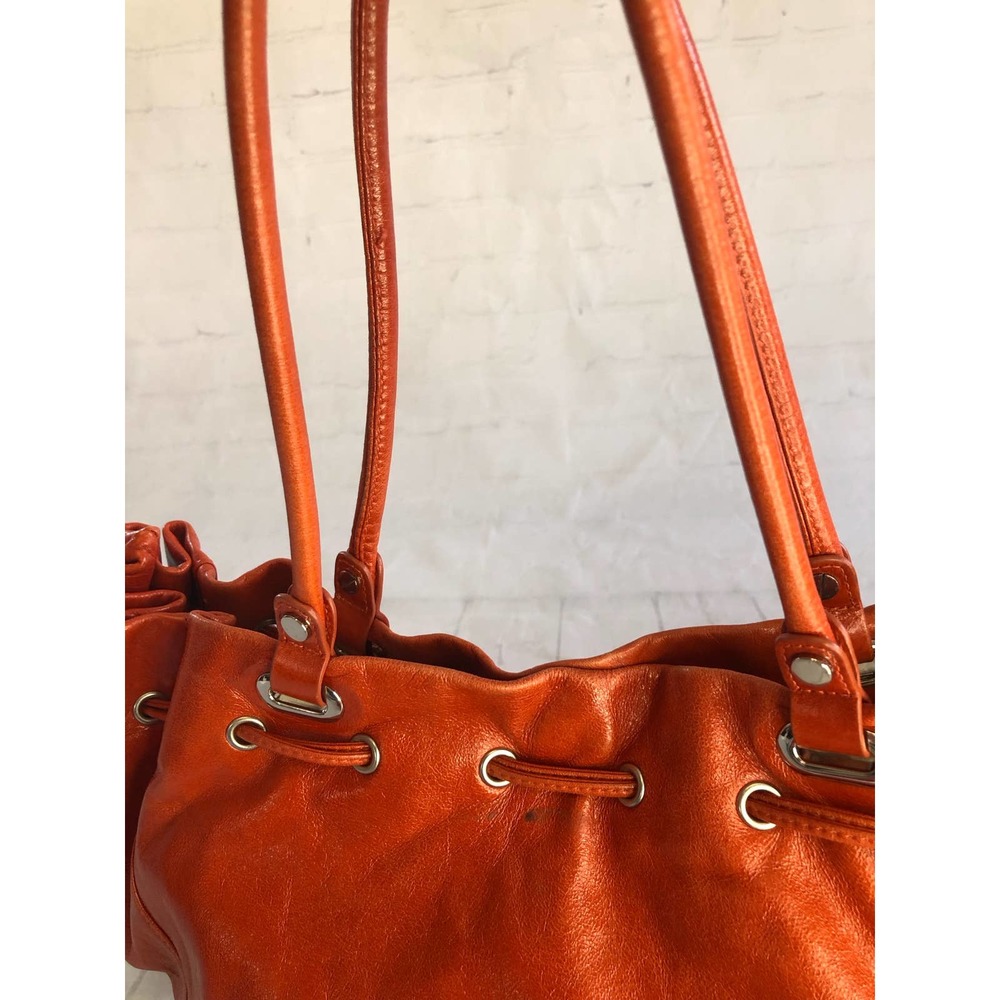 Prague orange leather hobo style bag, cinch top and ruffled trim edging.